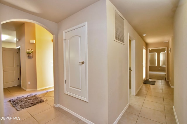 corridor featuring light tile patterned floors