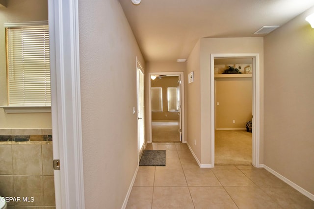 hallway with light tile patterned floors