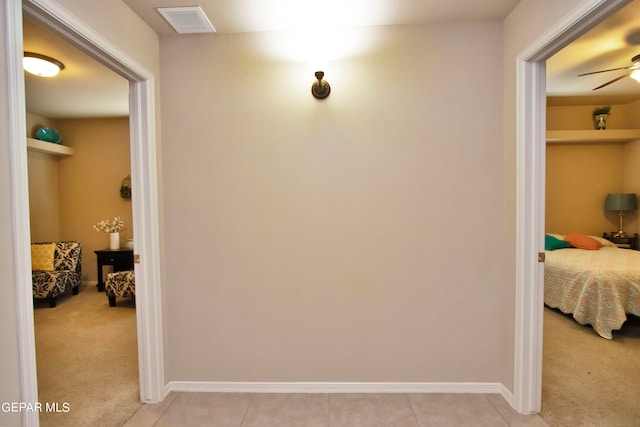 hallway featuring light carpet