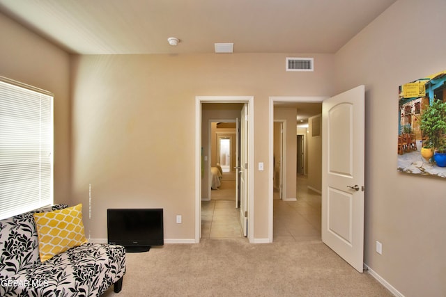 sitting room featuring light carpet