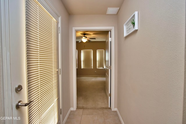 hallway with light colored carpet