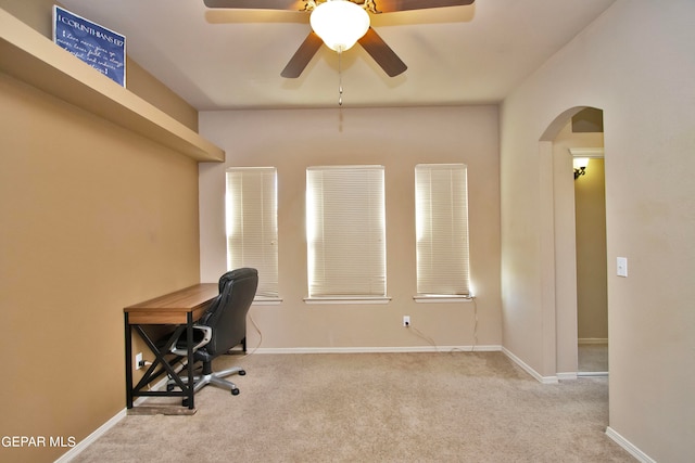 carpeted office space featuring ceiling fan