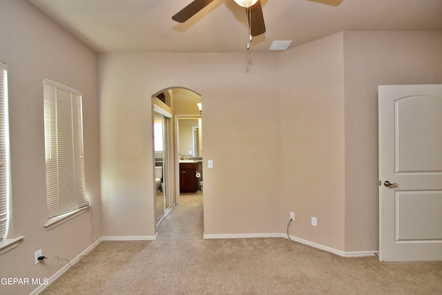 unfurnished room with ceiling fan and light colored carpet