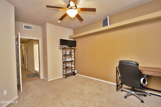 carpeted office space featuring ceiling fan