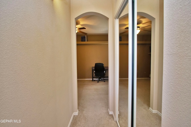 hallway with light colored carpet