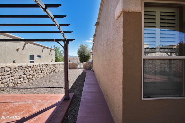 view of side of home featuring a pergola and a patio