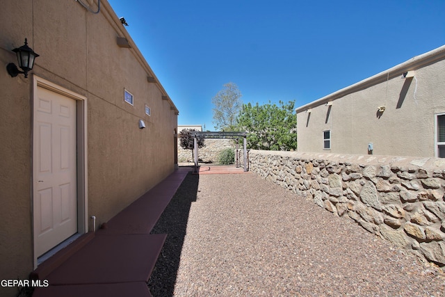 view of side of home with a pergola and a patio area