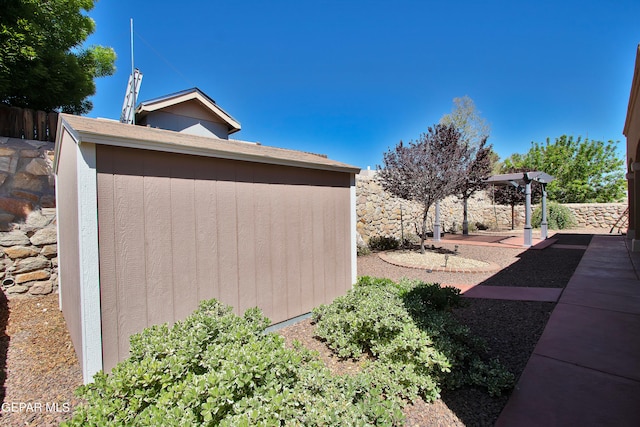 view of side of home featuring a storage unit