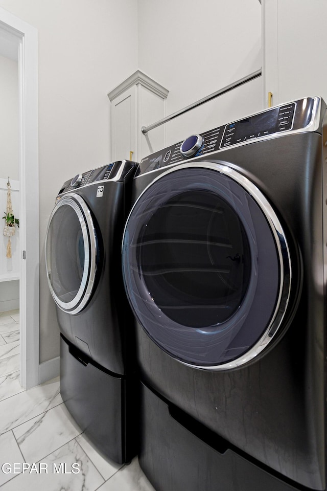 laundry room with cabinets and washer and dryer