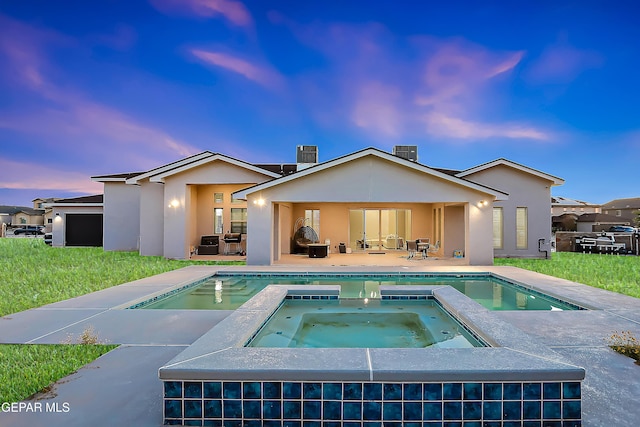 back house at dusk with a patio area, a yard, cooling unit, and a pool with hot tub