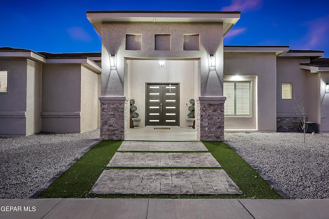 view of exterior entry at dusk