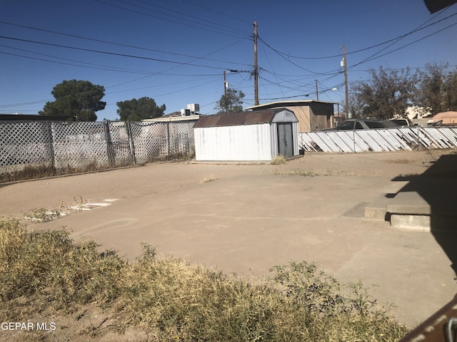 view of yard featuring a patio and a storage unit