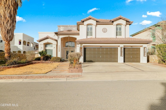 mediterranean / spanish home with a garage