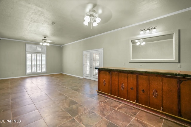 tiled empty room featuring crown molding, french doors, ceiling fan, and a textured ceiling