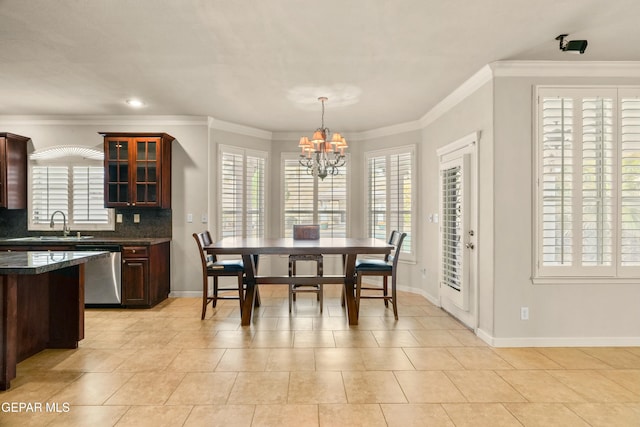 tiled dining space featuring a notable chandelier, ornamental molding, and sink