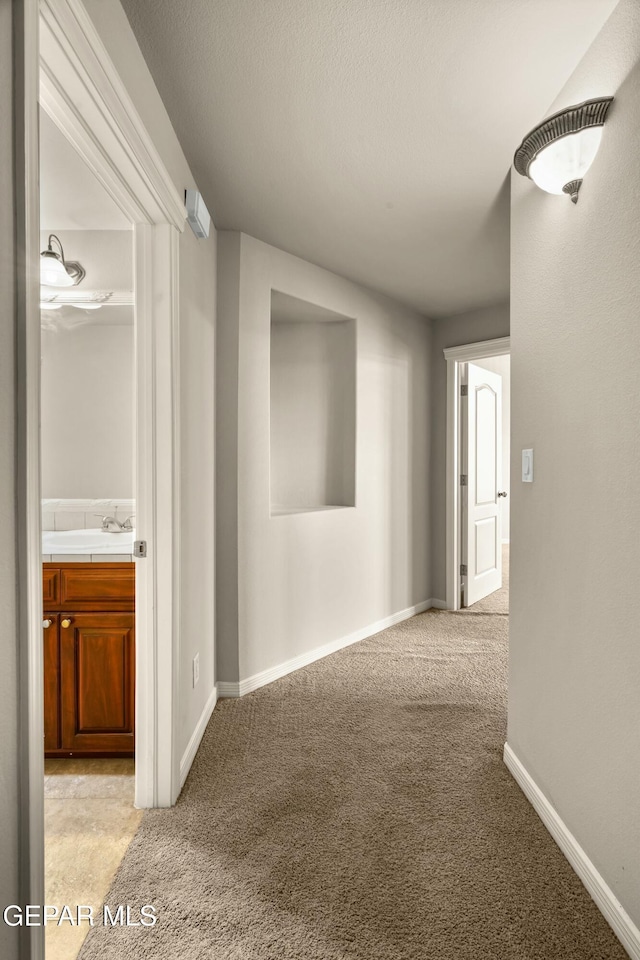 hallway featuring light carpet