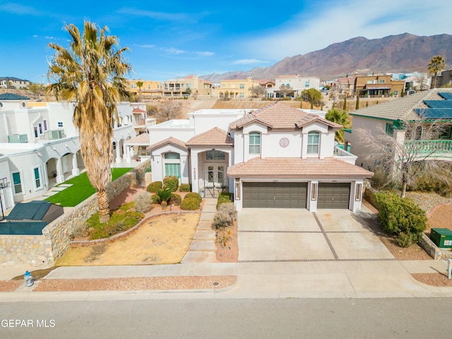 mediterranean / spanish house featuring a mountain view and a garage