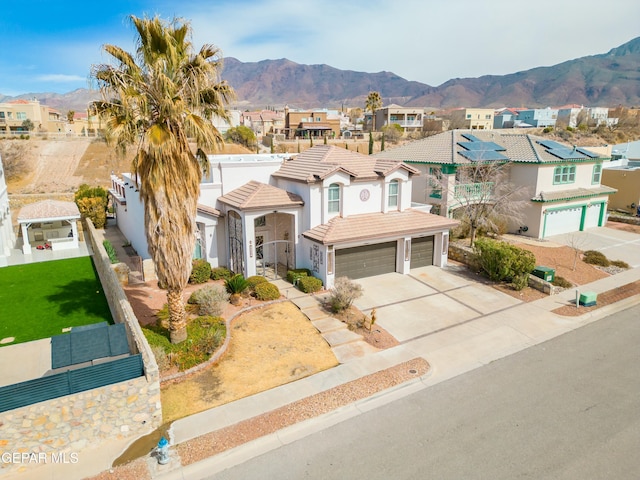 view of front of home with a mountain view and a garage