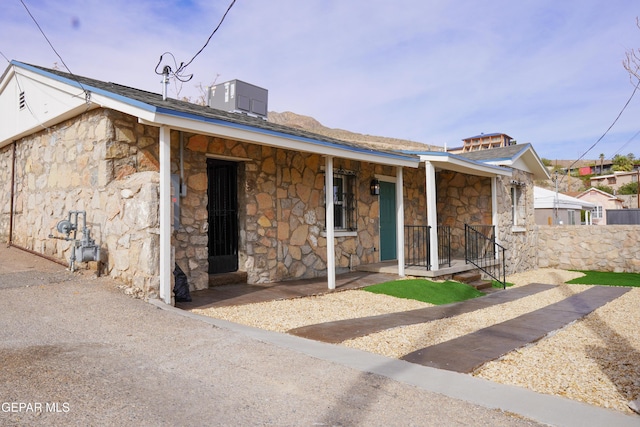 2406 Lebanon Rear, Rear, El Paso, TX 79930 - view of front of house featuring stone siding, a porch, and central AC