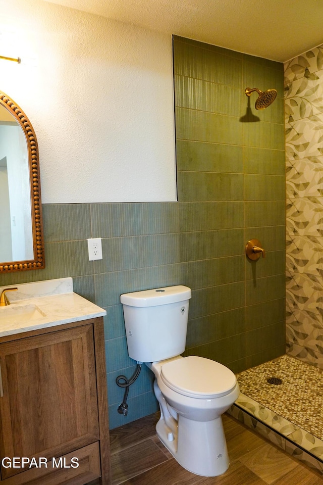 2406 Lebanon Rear, Rear, El Paso, TX 79930 - bathroom featuring tiled shower, toilet, vanity, wainscoting, and wood finished floors