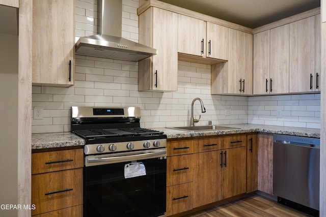 2406 Lebanon Rear, Rear, El Paso, TX 79930 - kitchen with wall chimney range hood, appliances with stainless steel finishes, a sink, light stone counters, and decorative backsplash
