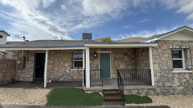 2406 Lebanon Rear, Rear, El Paso, TX 79930 - view of front of home with stone siding, a shingled roof, and central AC unit