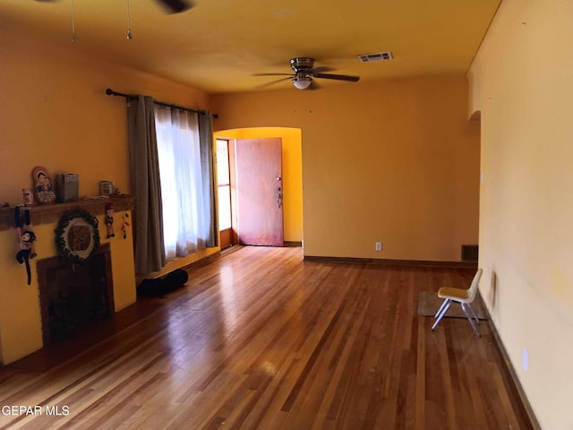 interior space featuring wood-type flooring and ceiling fan