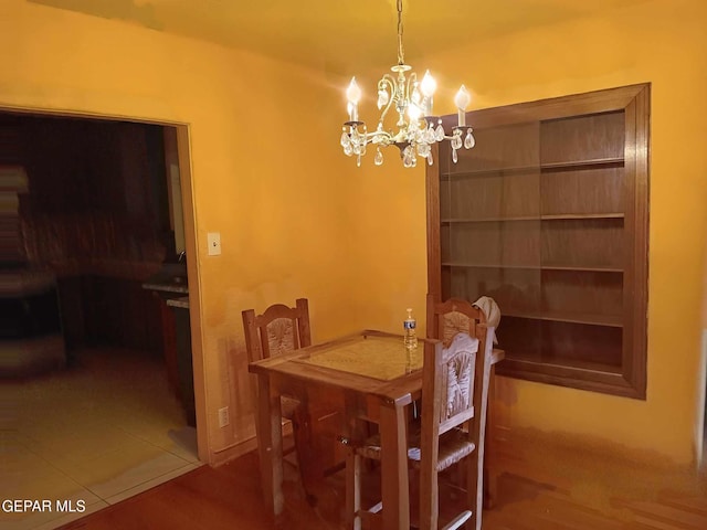 tiled dining room with an inviting chandelier