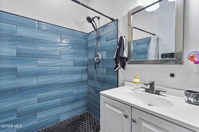 bathroom featuring vanity and a tile shower