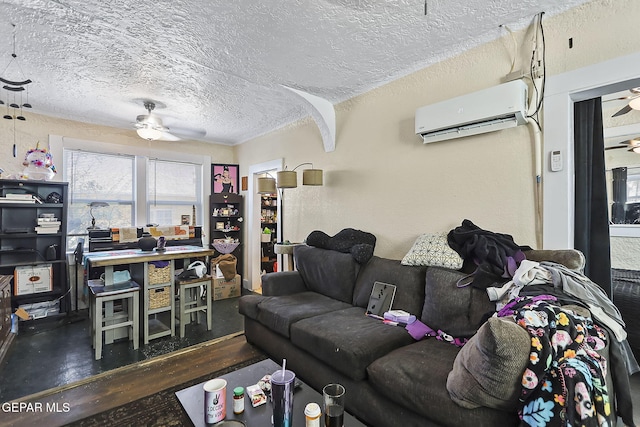 living room with a wall unit AC, ceiling fan, and a textured ceiling