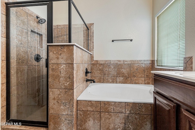 bathroom featuring vanity and separate shower and tub