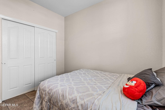 tiled bedroom featuring a closet