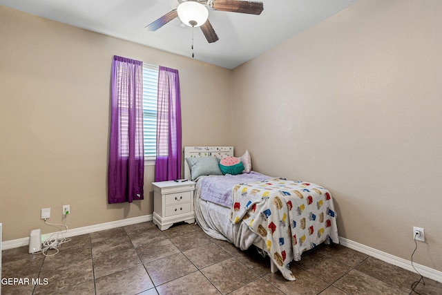 tiled bedroom featuring ceiling fan