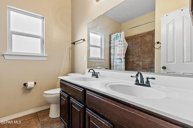 bathroom featuring tile patterned floors, vanity, curtained shower, and toilet