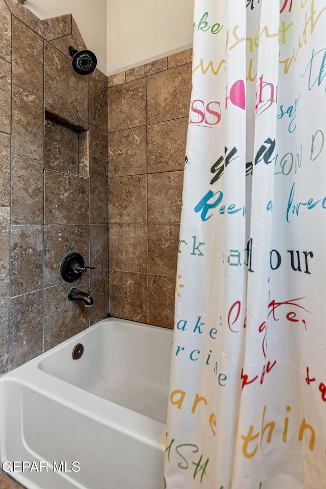 bathroom with shower / tub combo with curtain