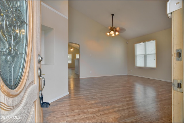 foyer with hardwood / wood-style flooring, vaulted ceiling, and ceiling fan