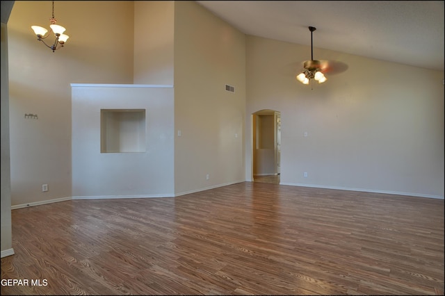 interior space with ceiling fan with notable chandelier, dark hardwood / wood-style floors, and high vaulted ceiling