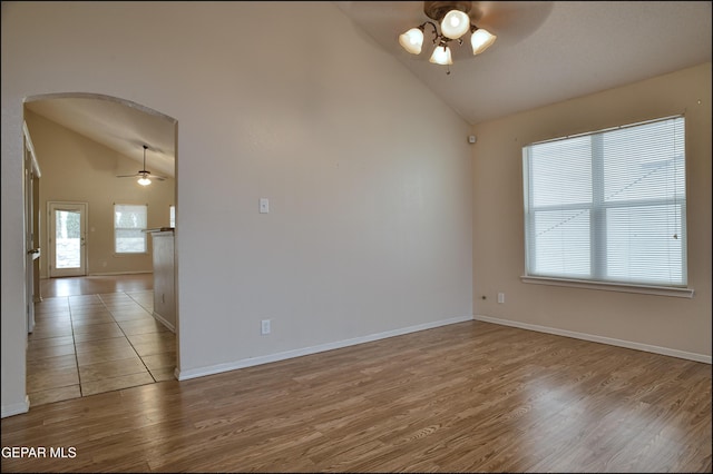 unfurnished room featuring ceiling fan, high vaulted ceiling, and light hardwood / wood-style flooring