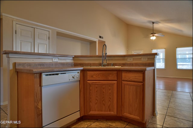 kitchen featuring dishwasher, high vaulted ceiling, sink, ceiling fan, and light tile patterned flooring