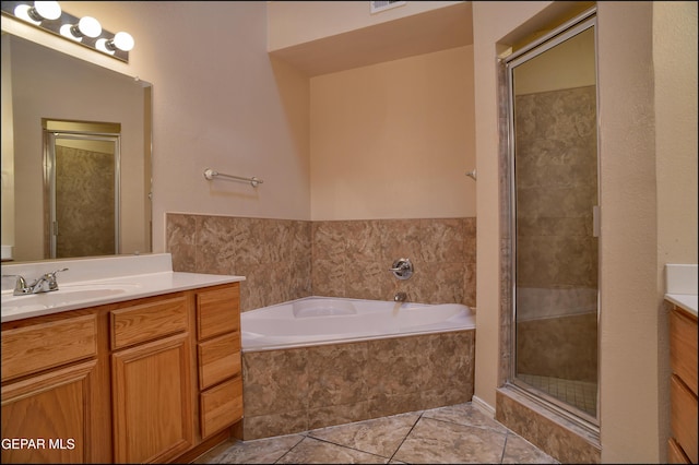 bathroom featuring tile patterned floors, vanity, and independent shower and bath