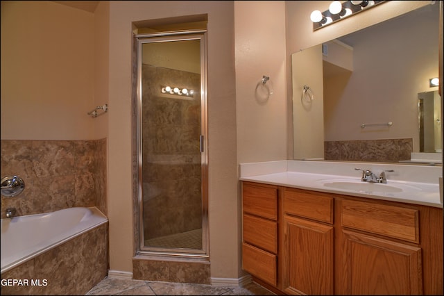 bathroom with shower with separate bathtub, vanity, and tile patterned floors