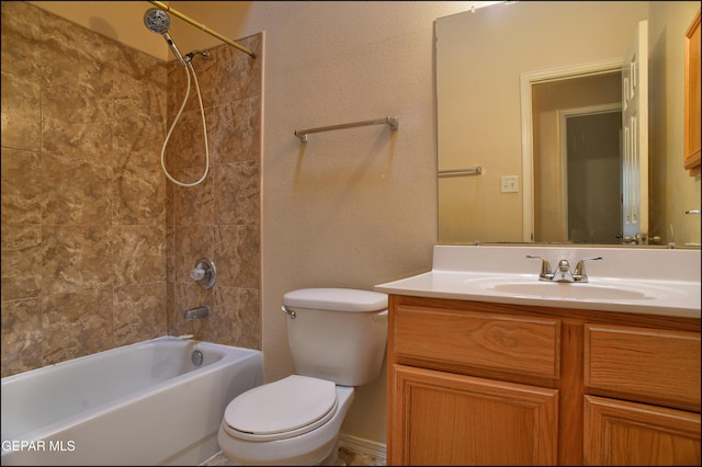 full bathroom with vanity, toilet, and tiled shower / bath