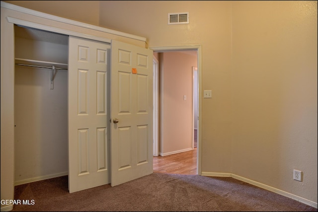 unfurnished bedroom featuring a closet and carpet floors