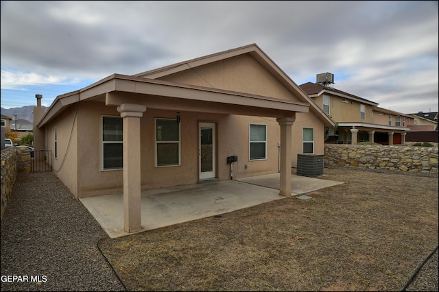 rear view of house with a patio and central AC