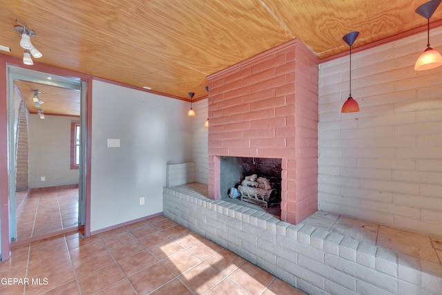 unfurnished living room with a fireplace, tile patterned floors, wooden ceiling, and brick wall