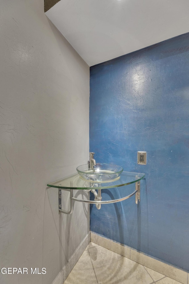 unfurnished dining area featuring tile patterned floors and sink