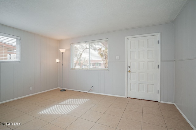 interior space featuring a textured ceiling and light tile patterned floors