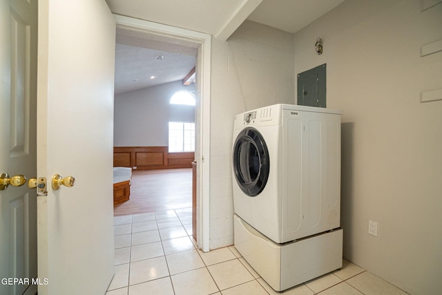 laundry room with washer / dryer, laundry area, electric panel, and light tile patterned floors