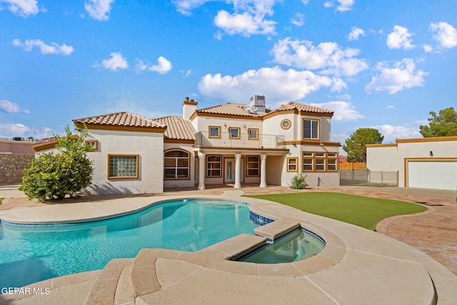 view of pool featuring a patio area and an in ground hot tub