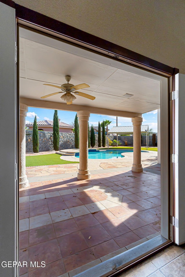 view of pool with ceiling fan and a patio